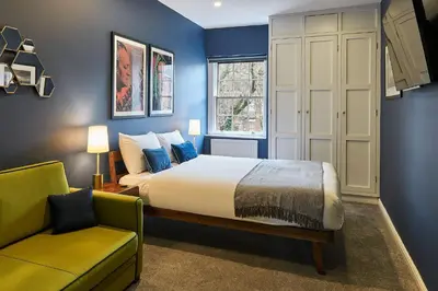 a bedroom with a king sized bed and a couch at Host & Stay - The Georgian Quarters at Falkner Street in Liverpool