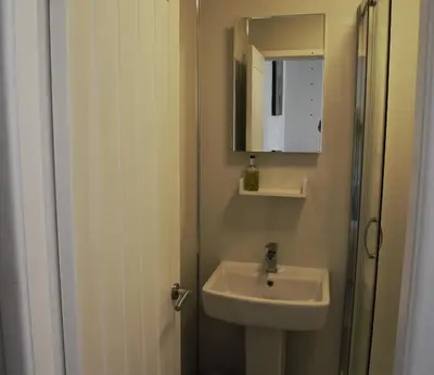 a bathroom with a sink and a mirror at Avenue Guest House in Blackpool