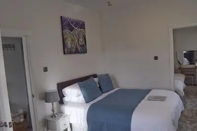a bedroom with a bed and a painting on the wall at Avenue Guest House in Blackpool