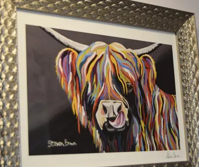 a painting of a colorful dog in a frame at Avenue Guest House in Blackpool