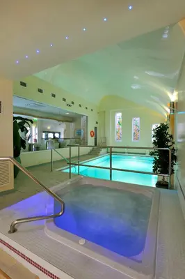 a large swimming pool in a building with a swimming pool at Clifton Park Hotel - Adults Only in Lytham St Annes