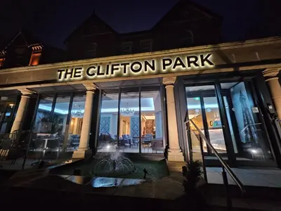 a building with a fountain in front of it at night at Clifton Park Hotel - Adults Only in Lytham St Annes