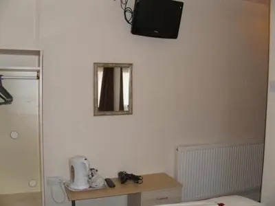 a room with a table and a mirror on the wall at Seaforth Guest House - Pleasure Beach in Blackpool