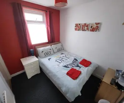 a small bedroom with a bed and a window at The Moorfield in Blackpool