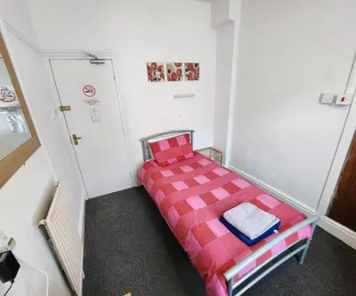 a small room with a bed in the corner at The Moorfield in Blackpool