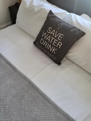 a black pillow sitting on top of a bed at 140 Bond - Holiday Home in Blackpool