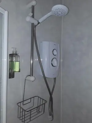a shower with a shower head in a bathroom at 140 Bond - Holiday Home in Blackpool