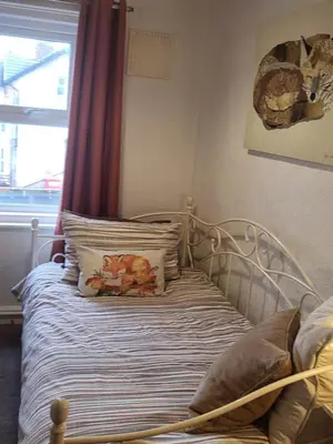 a bedroom with a bed with pillows and a window at 140 Bond - Holiday Home in Blackpool