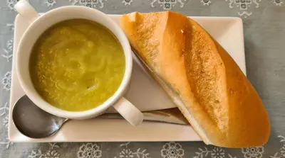 a plate with a sandwich and a cup of soup at The Pavilion Guest House in Millom