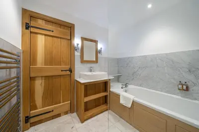 a bathroom with a tub and a sink and a bath tub at The Fleece Inn in Shireshead