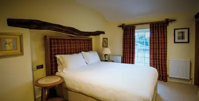 a bedroom with a white bed and a window at The Fleece Inn in Shireshead