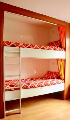 twolevel bunk beds in a room with a bed at The Liverpool Pod Travel Hostel in Liverpool