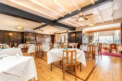 a dining room with white tables and chairs at The Headlands in Blackpool