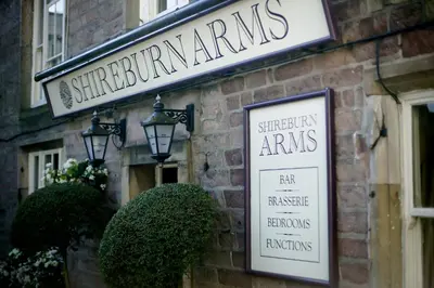 a sign on the side of a brick building at The Shireburn Arms in Clitheroe