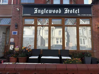 a shop with two chairs in front of a window at The Inglewood Hotel *Adults Only* in Blackpool