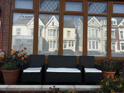 a couple of chairs sitting in front of a window at The Inglewood Hotel *Adults Only* in Blackpool