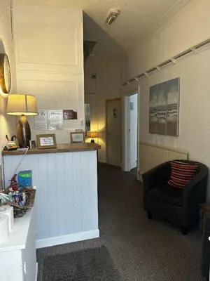 a living room with a couch and a chair at The Inglewood Hotel *Adults Only* in Blackpool