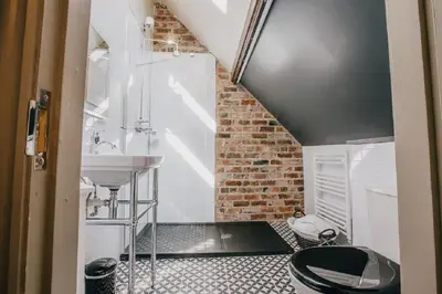 a small bathroom with a sink and a toilet at The Duke of Edinburgh Hotel & Bar in Barrow in Furness