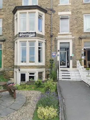 a building with a sign on the front of it at Westleigh B&B in Morecambe