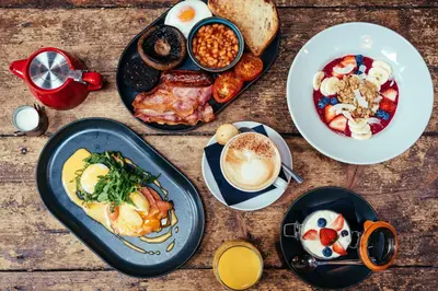 a table topped with plates of breakfast foods and coffee at The Sun Hotel & Bar in Lancaster