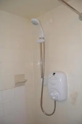 a shower with a shower head in a bathroom at Fortuna House Hotel in Blackpool