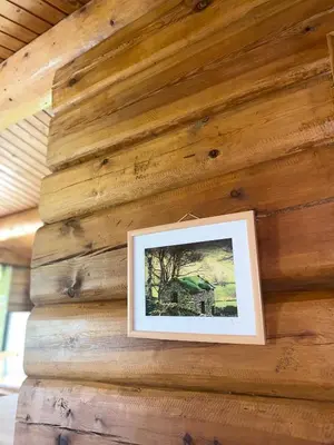 a picture on the wall of a log cabin at Log home village in Ulverston