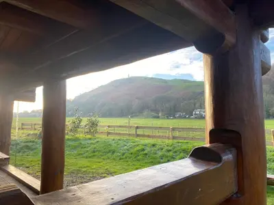 a view of a mountain from a window of a cabin at Log home village in Ulverston