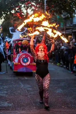a woman with red hair holding an umbrella in a parade at Edendale House in Southport