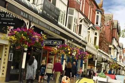 a group of people walking down a busy city street at Edendale House in Southport