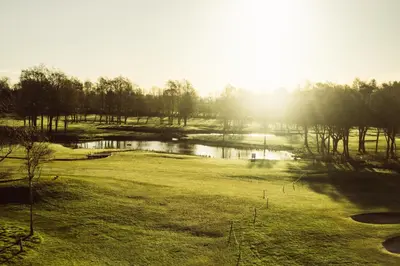 a view of a golf course with a pond at Formby Hall Golf Resort & Spa in Southport