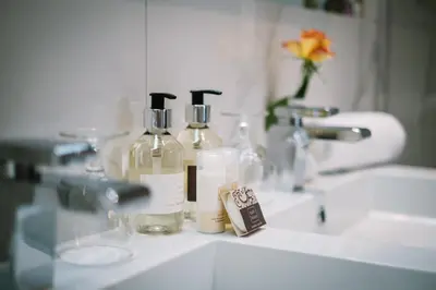 a bathroom sink with two bottles of soap on it at Lymestone Boutique Accommodation in Grange Over Sands