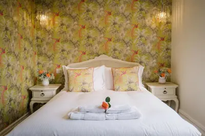 a bedroom with a bed with towels on it at Lymestone Boutique Accommodation in Grange Over Sands