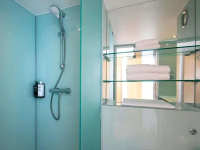 a bathroom with a shower and a glass shower stall at ibis Styles Haydock in Haydock