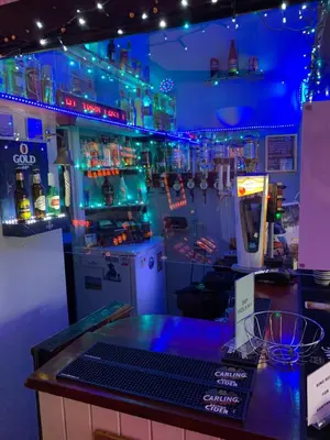 a bar with blue lights in a room at The Croydon in Blackpool
