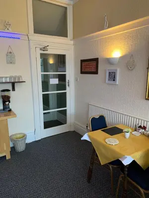 a dining room with a table and a window at The Croydon in Blackpool