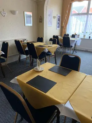 a classroom with tables and chairs in a room at The Croydon in Blackpool