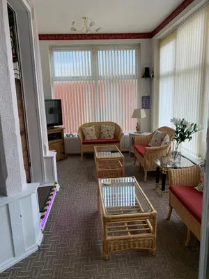 a living room with a couch and chairs and a tv at The Croydon in Blackpool