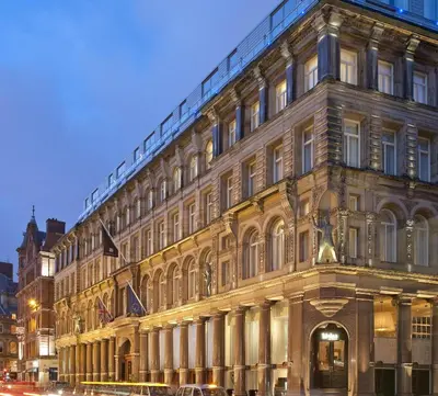 a large building on a city street at night at Hard Days Night Hotel Liverpool in Liverpool