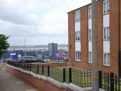 a brick building with a fence in front of it at Home with a view in Liverpool