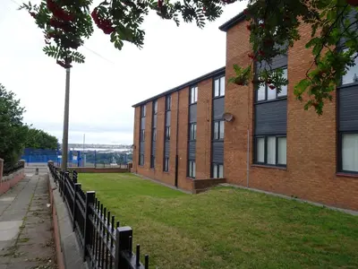 a brick building with a row of benches in front of it at Home with a view in Liverpool
