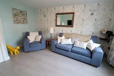 a living room with two blue couches and a mirror at In Our Liverpool Home Sleeps 5 in 2 Double & 1 Single Bedrooms in Liverpool