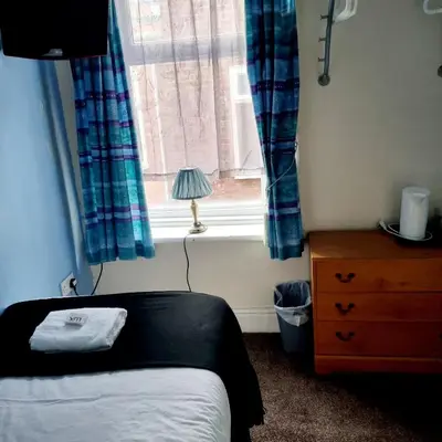 a bedroom with a bed and a window at The New Osterley Hotel in Blackpool