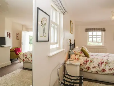 a bedroom with a bed and a window at Lane Head in Grange Over Sands