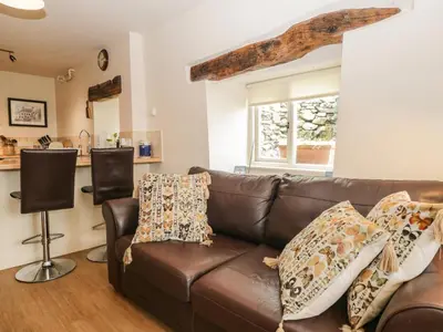a living room with a brown leather couch at Lane Head in Grange Over Sands