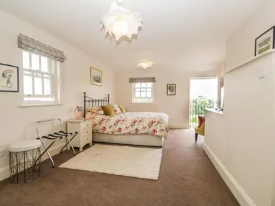 a bedroom with a bed and a chandelier at Lane Head in Grange Over Sands