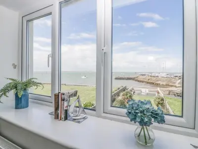 a window with a view of the ocean at Driftwood Cottage Roa Island Piel Island in Barrow in Furness