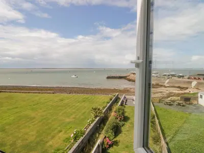 a view of the ocean from a window at Driftwood Cottage Roa Island Piel Island in Barrow in Furness