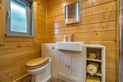 a bathroom with a toilet and a sink at Elm Lodge in Ulverston