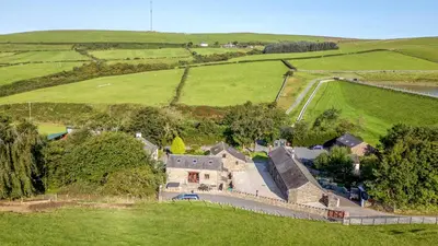 an aerial view of a house in a green field at Elm Lodge in Ulverston