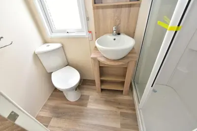 a small bathroom with a toilet and a sink at Mowbreck Park in Kirkham